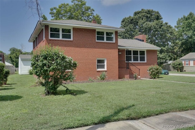 727 Teach St, Hampton, VA 23661 - tri-level home with a chimney, a front lawn, and brick siding