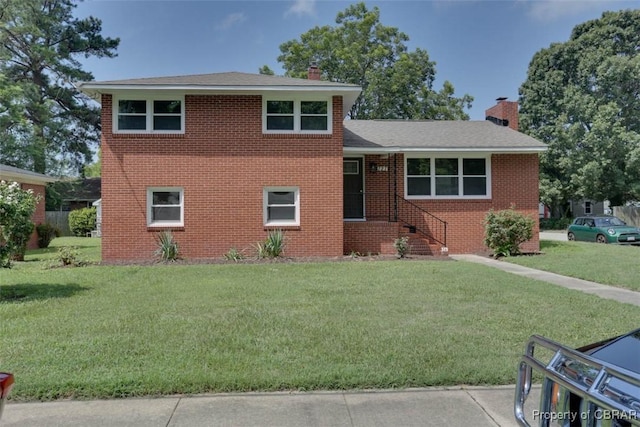 727 Teach St, Hampton, VA 23661 - tri-level home featuring a chimney, a front lawn, brick siding, and a shingled roof
