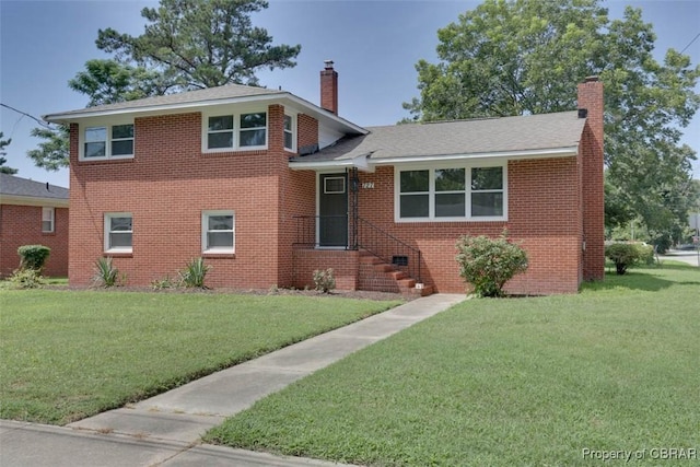727 Teach St, Hampton, VA 23661 - tri-level home with a chimney, a front lawn, and brick siding