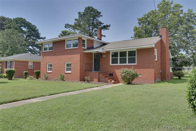 727 Teach St, Hampton, VA 23661 - tri-level home featuring a chimney, a front lawn, and brick siding