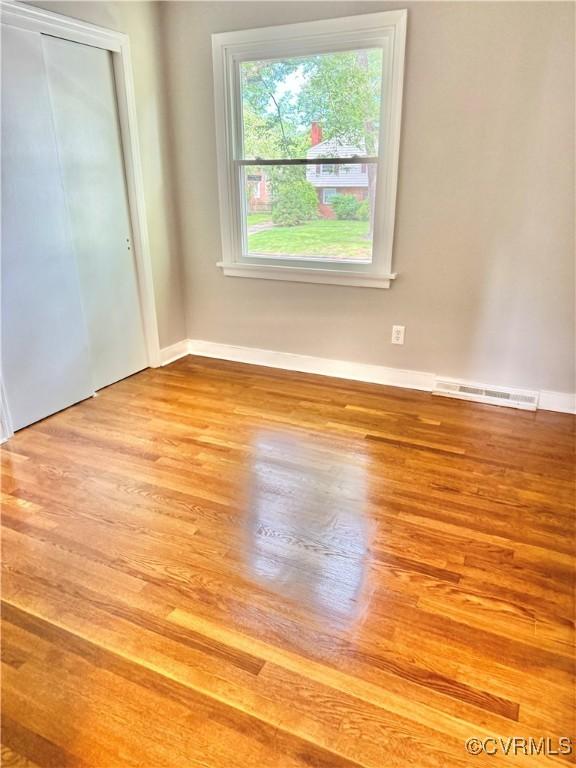 8409 Zell Ln, Henrico, VA 23229 - unfurnished bedroom featuring wood finished floors and a closet