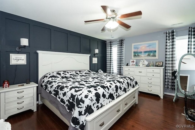 696 Anne Ln, Aylett, VA 23009 - bedroom with multiple windows, dark wood-style flooring, ceiling fan, and a decorative wall