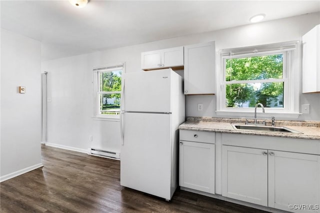 1110 Pine Ave, Hopewell, VA 23860 - kitchen with a baseboard heating unit, freestanding refrigerator, dark wood-style flooring, light stone countertops, and white cabinetry