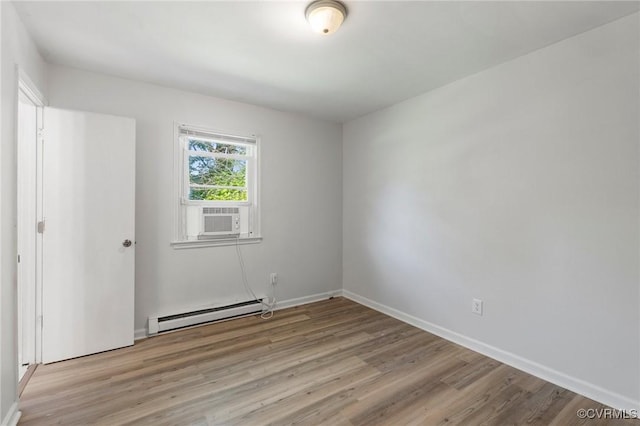1110 Pine Ave, Hopewell, VA 23860 - spare room featuring baseboard heating, cooling unit, and light wood-style floors