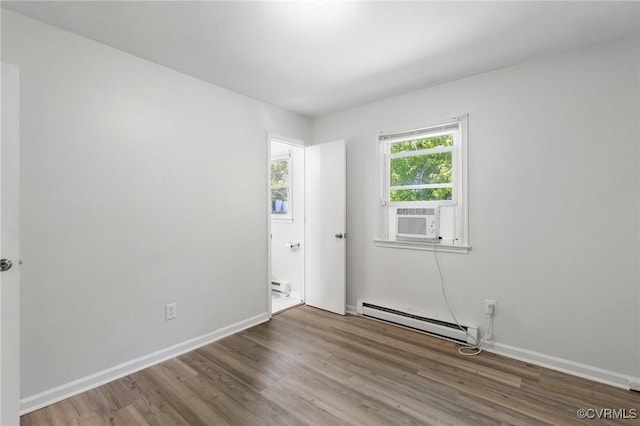 1110 Pine Ave, Hopewell, VA 23860 - unfurnished room featuring a baseboard heating unit, cooling unit, and wood finished floors