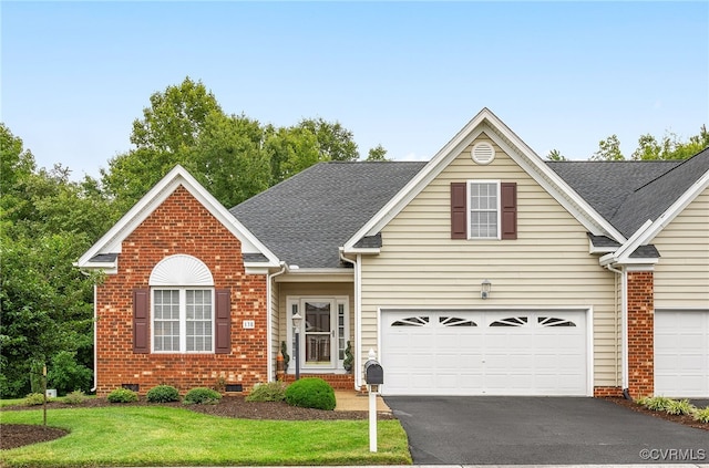 138 Carriage Point Ln, Glen Allen, VA 23059 - traditional-style home with asphalt driveway, brick siding, a front lawn, and a shingled roof