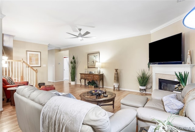 138 Carriage Point Ln, Glen Allen, VA 23059 - living room with stairs, light wood-style floors, crown molding, ceiling fan, and a glass covered fireplace