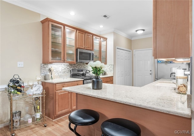 138 Carriage Point Ln, Glen Allen, VA 23059 - kitchen with appliances with stainless steel finishes, a peninsula, ornamental molding, light stone countertops, and backsplash