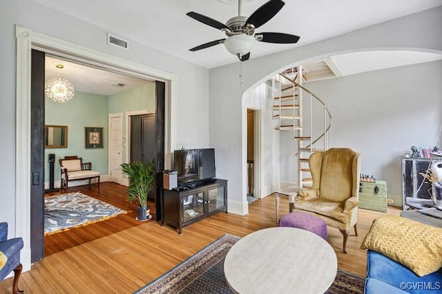 2024 Park Ave, Richmond, VA 23220 - living room with arched walkways, ceiling fan, stairs, wood finished floors, and a chandelier