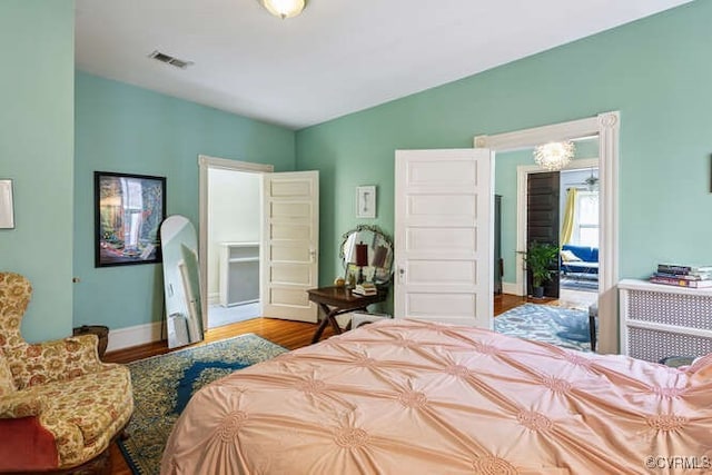 2024 Park Ave, Richmond, VA 23220 - bedroom featuring lofted ceiling, wood finished floors, and a chandelier