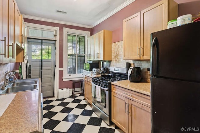 2024 Park Ave, Richmond, VA 23220 - kitchen with freestanding refrigerator, gas stove, dark floors, tasteful backsplash, and light countertops