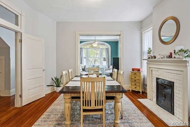 2024 Park Ave, Richmond, VA 23220 - dining room featuring wood finished floors and a brick fireplace