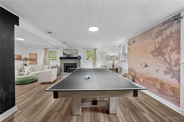 2226 Highland Dr, Powhatan, VA 23139 - game room featuring wood finished floors, a fireplace, wallpapered walls, and an accent wall