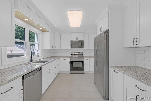 366 Patterson Rd, Mattaponi, VA 23110 - kitchen with stainless steel appliances, white cabinetry, light stone countertops, and tasteful backsplash
