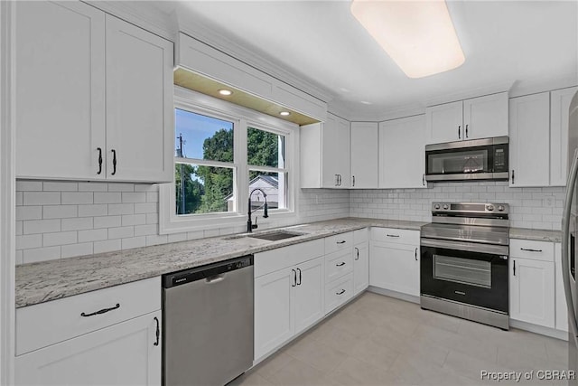 366 Patterson Rd, Mattaponi, VA 23110 - kitchen featuring appliances with stainless steel finishes, white cabinets, light stone countertops, and decorative backsplash