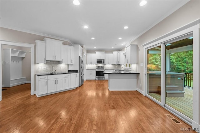 11499 Jack Ln, Hanover, VA 23146 - kitchen with stainless steel appliances, ornamental molding, dark countertops, tasteful backsplash, and white cabinetry