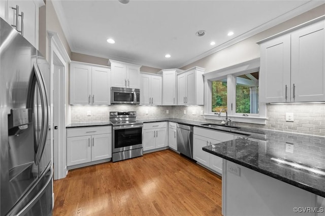 11499 Jack Ln, Hanover, VA 23146 - kitchen with appliances with stainless steel finishes, ornamental molding, backsplash, white cabinetry, and recessed lighting