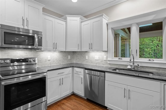 11499 Jack Ln, Hanover, VA 23146 - kitchen featuring stainless steel appliances, dark stone countertops, white cabinets, decorative backsplash, and wood finished floors