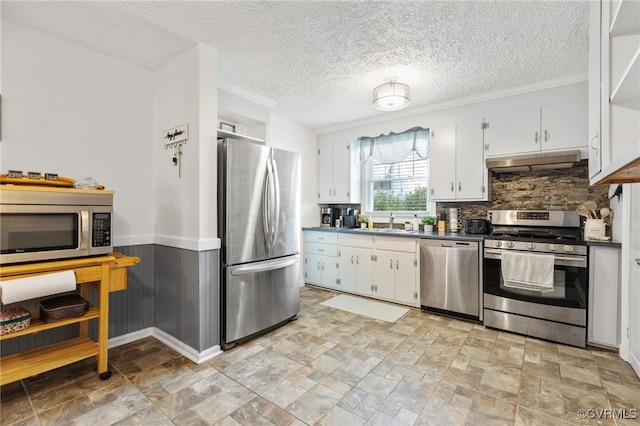 415 Crescent Ave, Colonial Heights, VA 23834 - kitchen with appliances with stainless steel finishes, under cabinet range hood, dark countertops, backsplash, and white cabinets