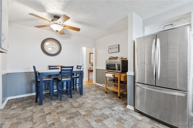 415 Crescent Ave, Colonial Heights, VA 23834 - dining area with a textured ceiling, a ceiling fan, stone finish floors, and a wainscoted wall