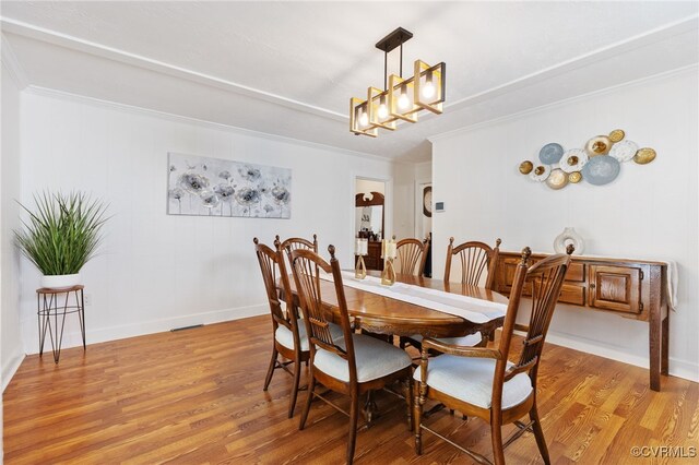 415 Crescent Ave, Colonial Heights, VA 23834 - dining area featuring light wood-type flooring, ornamental molding, and a chandelier