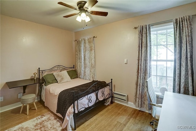 1410 W Clay St, Richmond, VA 23220 - bedroom featuring baseboard heating, light wood-style floors, and a ceiling fan