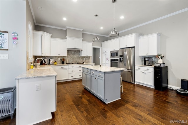 16507 Hannington Dr, Midlothian, VA 23112 - kitchen featuring appliances with stainless steel finishes, backsplash, ornamental molding, white cabinetry, and light stone counters