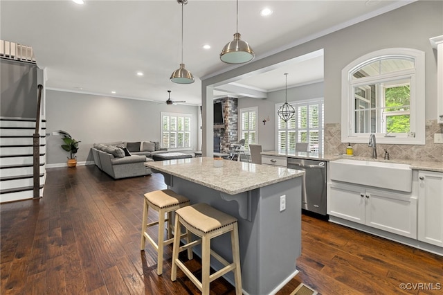 16507 Hannington Dr, Midlothian, VA 23112 - kitchen with dishwasher, light stone countertops, crown molding, dark wood finished floors, and a center island