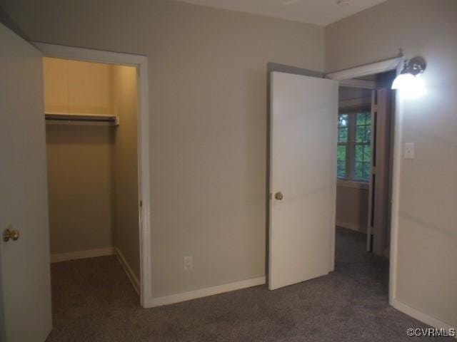 5220 Castlewood Rd Unit E, Chesterfield, VA 23234 - unfurnished bedroom with dark colored carpet, a walk in closet, and a closet