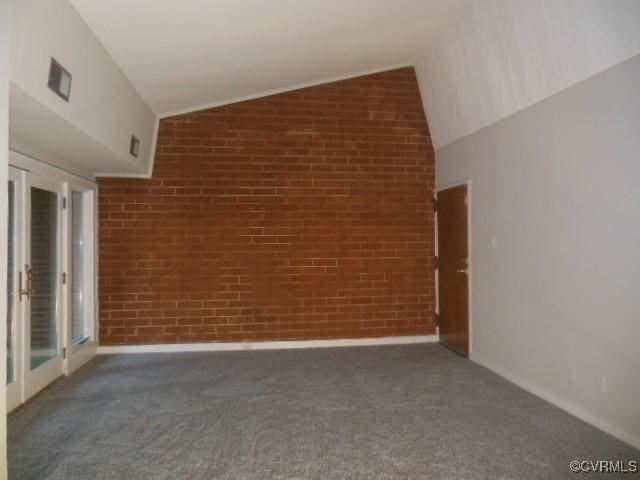 5220 Castlewood Rd Unit E, Chesterfield, VA 23234 - empty room with carpet flooring, vaulted ceiling, and brick wall