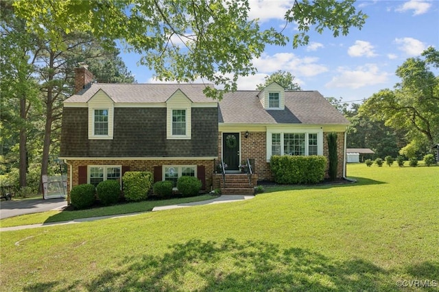 4619 Otterdale Rd, Moseley, VA 23120 - view of front of house featuring a front yard, brick siding, roof with shingles, and a chimney