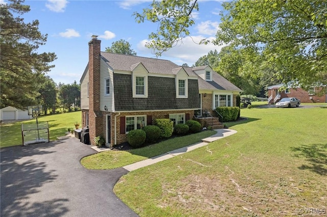 4619 Otterdale Rd, Moseley, VA 23120 - view of front of property featuring brick siding, a front yard, a chimney, and asphalt driveway