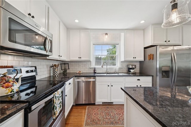 4619 Otterdale Rd, Moseley, VA 23120 - kitchen with stainless steel appliances, light wood finished floors, white cabinetry, recessed lighting, and decorative backsplash