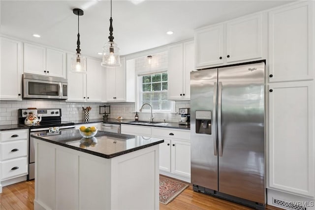 4619 Otterdale Rd, Moseley, VA 23120 - kitchen with stainless steel appliances, light wood-style flooring, white cabinetry, a center island, and recessed lighting