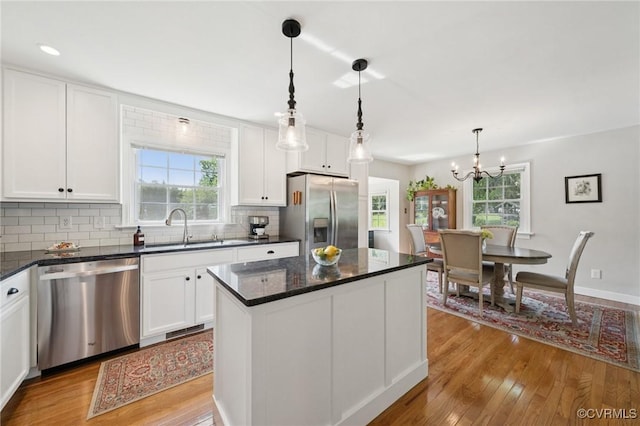 4619 Otterdale Rd, Moseley, VA 23120 - kitchen with stainless steel appliances, light wood finished floors, decorative backsplash, and white cabinets