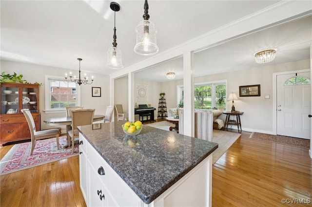 4619 Otterdale Rd, Moseley, VA 23120 - kitchen featuring a chandelier, light wood-style floors, white cabinets, and a center island