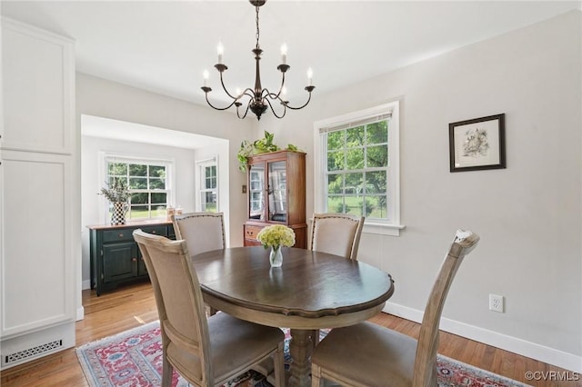 4619 Otterdale Rd, Moseley, VA 23120 - dining room featuring a chandelier, plenty of natural light, and light wood-style flooring