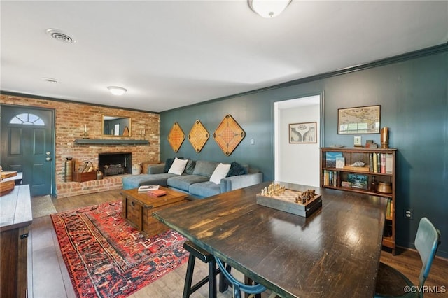 4619 Otterdale Rd, Moseley, VA 23120 - living room featuring a brick fireplace, wood finished floors, and crown molding