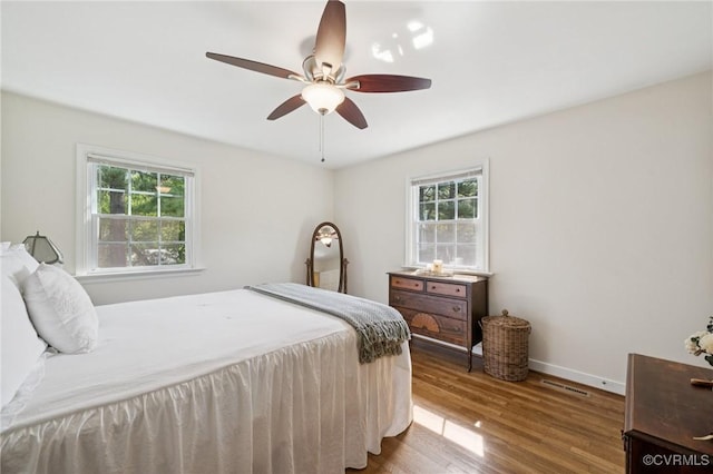 4619 Otterdale Rd, Moseley, VA 23120 - bedroom featuring multiple windows, wood finished floors, and ceiling fan