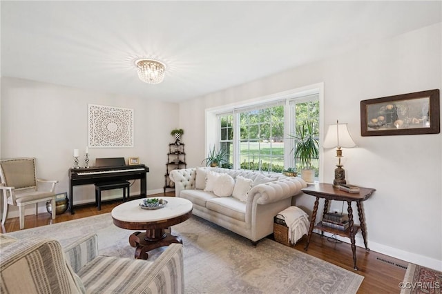4619 Otterdale Rd, Moseley, VA 23120 - living room featuring a chandelier and wood finished floors