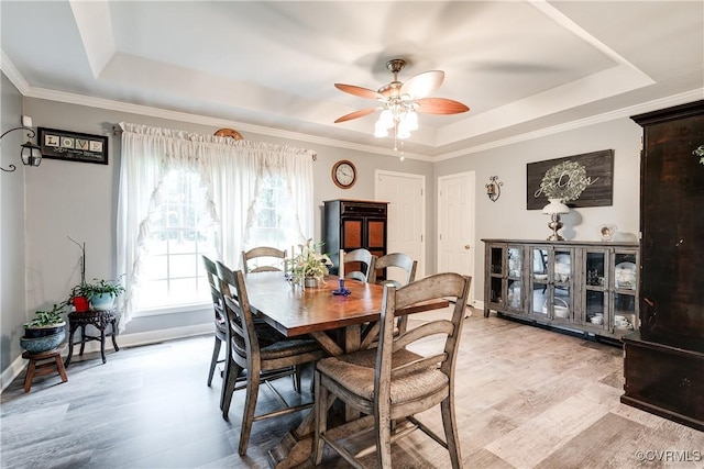 698 Quail Crossing Rd, Burkeville, VA 23922 - dining room featuring a tray ceiling, a ceiling fan, light wood-type flooring, and crown molding