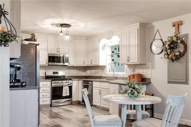 698 Quail Crossing Rd, Burkeville, VA 23922 - kitchen featuring appliances with stainless steel finishes, backsplash, dark countertops, white cabinets, and crown molding
