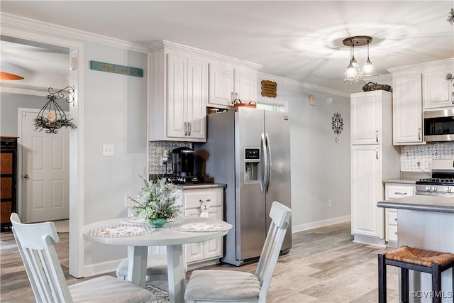 698 Quail Crossing Rd, Burkeville, VA 23922 - kitchen featuring stainless steel appliances, decorative backsplash, light wood-type flooring, ornamental molding, and white cabinetry