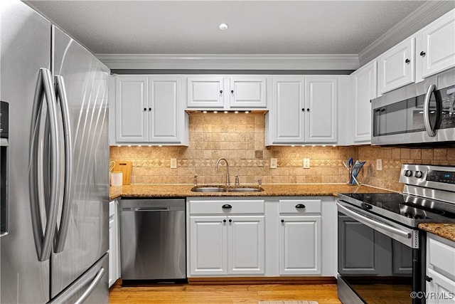 5019 Misty Spring Dr, Midlothian, VA 23112 - kitchen with appliances with stainless steel finishes, crown molding, white cabinetry, light stone counters, and tasteful backsplash