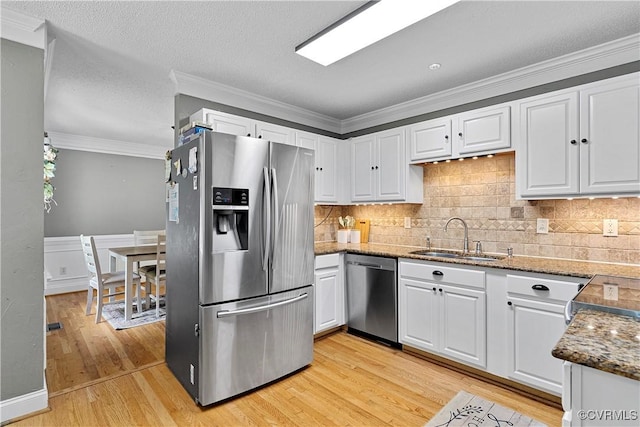 5019 Misty Spring Dr, Midlothian, VA 23112 - kitchen with stainless steel appliances, white cabinetry, light wood finished floors, dark stone countertops, and backsplash