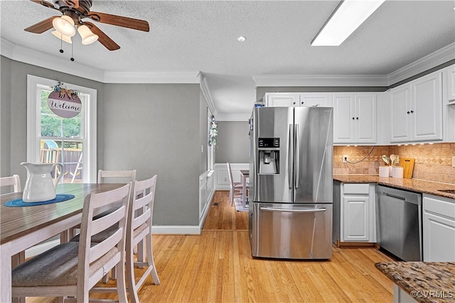 5019 Misty Spring Dr, Midlothian, VA 23112 - kitchen with appliances with stainless steel finishes, light wood-style flooring, white cabinetry, crown molding, and light stone countertops