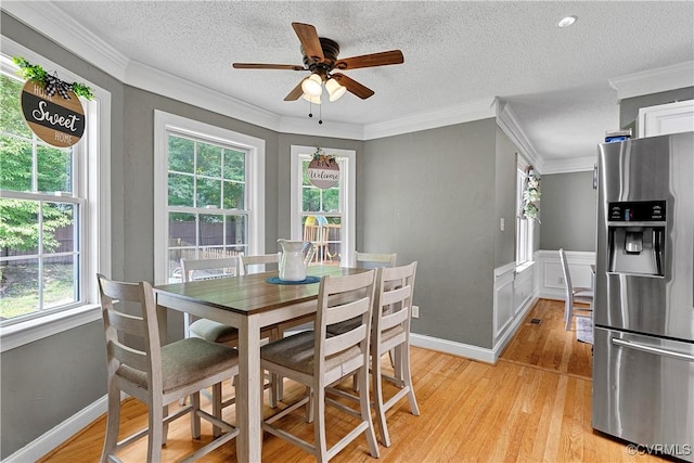 5019 Misty Spring Dr, Midlothian, VA 23112 - dining space with a ceiling fan, light wood-style flooring, a textured ceiling, ornamental molding, and wainscoting