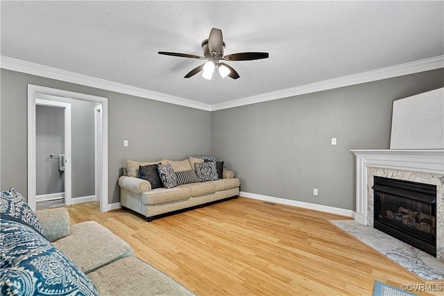 5019 Misty Spring Dr, Midlothian, VA 23112 - living room featuring crown molding, a fireplace, ceiling fan, wood finished floors, and a textured ceiling