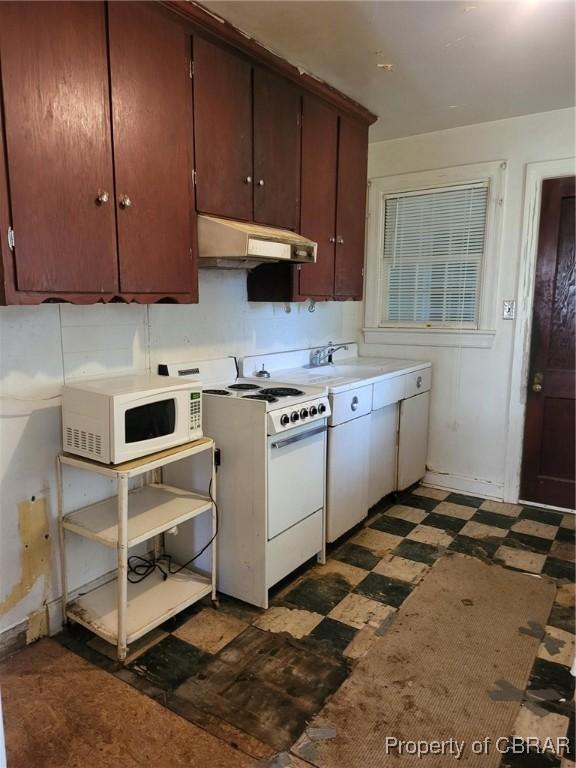 122 Longhill Rd, Williamsburg, VA 23185 - kitchen with white appliances, under cabinet range hood, dark flooring, and light countertops