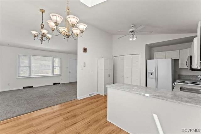 7470 Old Grove Gln, Mechanicsville, VA 23111 - kitchen with white refrigerator with ice dispenser, stainless steel microwave, a peninsula, lofted ceiling, and range